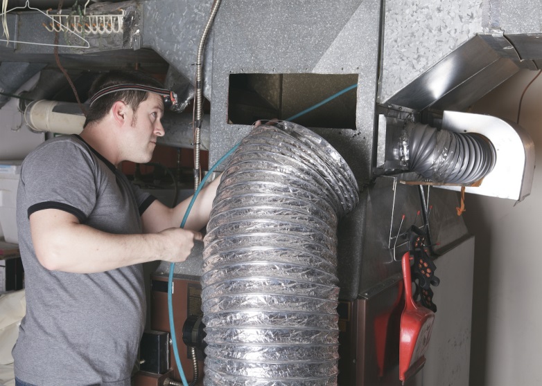 hvac technician cleaning air ducts